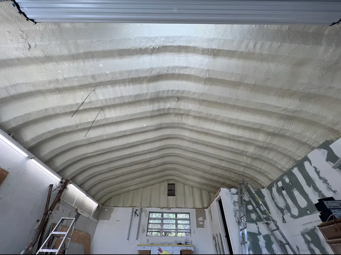 Spray polyurethane foam applied to the underside of a metal roof deck in Mack